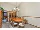 Traditional dining room featuring a wood table, chandelier, and a hutch for displaying china and glassware at 4231 S Fairplay Cir # A, Aurora, CO 80014