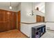 Bright entryway with wood floors, a contemporary light fixture and a display shelf by the staircase at 4231 S Fairplay Cir # A, Aurora, CO 80014