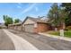 Brick townhome featuring attached garages and manicured lawn under a blue sky with some clouds at 4231 S Fairplay Cir # A, Aurora, CO 80014