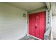 Eye-catching red front door with house number, accompanied by a modern exterior light fixture at 4231 S Fairplay Cir # A, Aurora, CO 80014