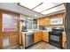 Well-equipped kitchen with modern appliances, wood cabinets, and plenty of counter space for meal preparation at 4231 S Fairplay Cir # A, Aurora, CO 80014