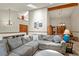 Bright, open concept living room features vaulted ceiling with exposed wood beam, skylights and gray sectional sofa at 4231 S Fairplay Cir # A, Aurora, CO 80014