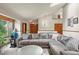 Bright living room with vaulted ceiling, skylights, and a large comfy sectional sofa with view of the front yard at 4231 S Fairplay Cir # A, Aurora, CO 80014