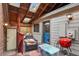 Private patio featuring skylights, wood decking, and a door with a pet door leading into the home at 4231 S Fairplay Cir # A, Aurora, CO 80014