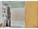 Bathroom featuring a shower over tub with decorative curtain and a storage shelf at 1662 S Blackhawk Way # A, Aurora, CO 80012