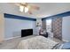 Bedroom showcasing light blue walls, a TV, chair, and a window with decorative curtains at 1662 S Blackhawk Way # A, Aurora, CO 80012