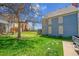 Exterior view of a home with a lush green lawn and mature tree at 1662 S Blackhawk Way # A, Aurora, CO 80012