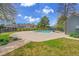 Community pool featuring a large concrete patio and black metal fencing, surrounded by lush greenery at 1662 S Blackhawk Way # A, Aurora, CO 80012