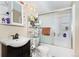 Clean bathroom with vanity, mirrored cabinet, and shower-tub with sliding glass door at 1143 Lamar St # 6, Lakewood, CO 80214