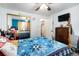Bright bedroom with light blue walls, ceiling fan, and mirrored closet doors at 1143 Lamar St # 6, Lakewood, CO 80214
