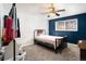 Simple bedroom with a full-sized bed, a window for natural light, and blue accent wall at 1143 Lamar St # 6, Lakewood, CO 80214