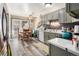 Charming eat-in kitchen with gray cabinets, wood-look flooring, and stainless steel sink at 1143 Lamar St # 6, Lakewood, CO 80214