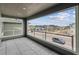 Balcony with a view of a quiet neighborhood showcasing homes, a street, and a car at 8480 Eagle River St, Littleton, CO 80125