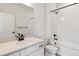 Clean bathroom featuring a modern sink, toilet, and bathtub with white tiled walls and black hardware at 8480 Eagle River St, Littleton, CO 80125