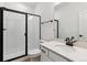 Bathroom featuring a shower with a glass enclosure and modern fixtures at 8480 Eagle River St, Littleton, CO 80125