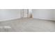 Large carpeted bedroom with multiple doorways and a neutral color palette at 8480 Eagle River St, Littleton, CO 80125