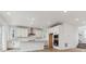 Modern kitchen with white cabinets, stainless steel appliances, and a center island at 8480 Eagle River St, Littleton, CO 80125
