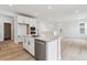 Spacious kitchen with island, stainless steel appliances, and open access to the living space at 8480 Eagle River St, Littleton, CO 80125