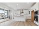 Bright kitchen featuring white cabinets, a center island, and stainless steel appliances at 8480 Eagle River St, Littleton, CO 80125