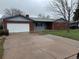 Classic brick ranch-style home with a spacious driveway and well-kept exterior, ideal for comfortable living at 1654 Longbranch St, Strasburg, CO 80136