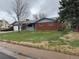 Charming single-story brick home with a well-maintained lawn and attached garage, perfect for suburban living at 1654 Longbranch St, Strasburg, CO 80136