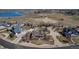 Expansive aerial view showcasing the home, its large lot, and surrounding neighborhood with pond at 3545 Cottonwood Cir, Longmont, CO 80504