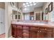 Elegant bathroom featuring a double sink vanity, decorative mirrors, and tiled backsplash at 3545 Cottonwood Cir, Longmont, CO 80504