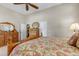 An elegant bedroom features a bed with floral bedding, ornate wooden furniture, and neutral walls at 3545 Cottonwood Cir, Longmont, CO 80504