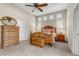 A spacious bedroom has a ceiling fan, carpet, and large windows with window shutters at 3545 Cottonwood Cir, Longmont, CO 80504