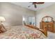 A spacious bedroom has a ceiling fan, carpet, and sliding glass doors at 3545 Cottonwood Cir, Longmont, CO 80504