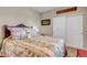 Comfortable bedroom featuring a floral comforter and a large closet with sliding doors at 3545 Cottonwood Cir, Longmont, CO 80504