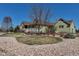Charming home exterior featuring a cozy front porch, lush lawn, and beautiful landscaping at 3545 Cottonwood Cir, Longmont, CO 80504