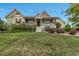 Charming home with a well-manicured lawn, mature landscaping, and inviting front porch at 3545 Cottonwood Cir, Longmont, CO 80504