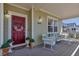 Inviting front porch with seating, floral accents, and well-maintained facade of this lovely home at 3545 Cottonwood Cir, Longmont, CO 80504