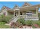 Welcoming front porch with seating and mature landscaping, enhancing the curb appeal at 3545 Cottonwood Cir, Longmont, CO 80504