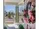 Front porch with flower-adorned door wreath and decorative potted plants at 3545 Cottonwood Cir, Longmont, CO 80504