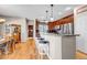 Open kitchen featuring a breakfast bar with seating, hardwood floors, and views of the dining area at 3545 Cottonwood Cir, Longmont, CO 80504