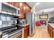 Open kitchen layout includes stainless steel appliances and breakfast bar that opens to living area at 3545 Cottonwood Cir, Longmont, CO 80504