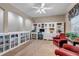 Home office with built-in shelving, desk, and cozy seating area at 3545 Cottonwood Cir, Longmont, CO 80504