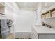 Clean bathroom with white subway tiles, modern fixtures, and built-in storage shelves at 8736 W 46Th Ave, Wheat Ridge, CO 80033