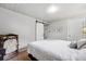 Well-lit bedroom with a sliding barn door closet and a full door to the hall at 8736 W 46Th Ave, Wheat Ridge, CO 80033