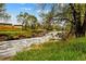 Scenic view of a creek surrounded by green grass and trees, offering a tranquil natural backdrop at 8736 W 46Th Ave, Wheat Ridge, CO 80033