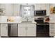 Kitchen with stainless steel appliances and bright white cabinets at 8736 W 46Th Ave, Wheat Ridge, CO 80033