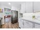 Galley kitchen with stainless appliances and direct access to living room at 8736 W 46Th Ave, Wheat Ridge, CO 80033