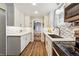 Modern kitchen with white cabinets, stainless steel appliances and stone tile backsplash at 8736 W 46Th Ave, Wheat Ridge, CO 80033