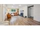Stylish living room features a brick accent wall, a cozy fireplace, and ample natural light from the large window at 8736 W 46Th Ave, Wheat Ridge, CO 80033