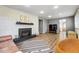 Bright open living room with brick fireplace and vinyl floors at 8736 W 46Th Ave, Wheat Ridge, CO 80033