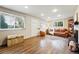 Cozy living room with hardwood floors, brick fireplace and leather sofa at 8736 W 46Th Ave, Wheat Ridge, CO 80033
