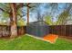 Outdoor storage shed on a lush green lawn, surrounded by mature trees, and a wooden fence, offering a storage solution at 8736 W 46Th Ave, Wheat Ridge, CO 80033