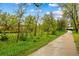 Picturesque walking path meandering through lush greenery, providing a serene and inviting space for outdoor recreation at 8736 W 46Th Ave, Wheat Ridge, CO 80033